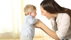 Mother helping her baby son in his first steps Alzein Pediatrics