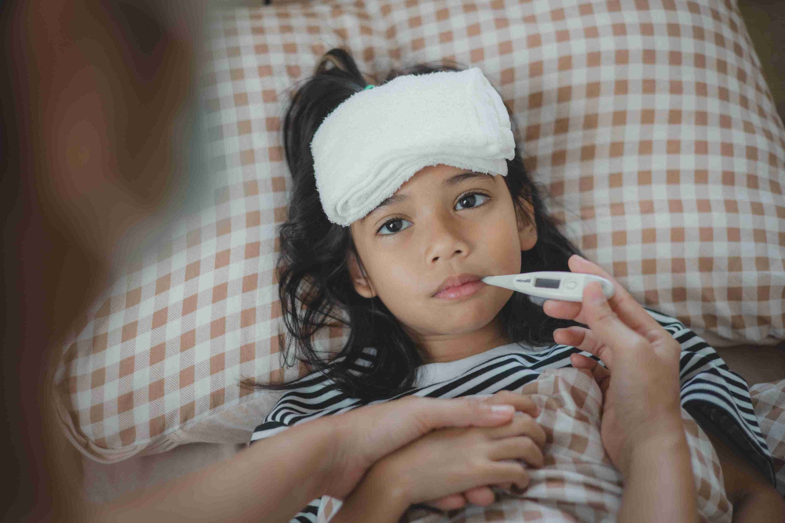 Imgi 226 a young girl is being checked for a fever by a wom 2024 05 06 20 11 55 utc 11zon scaled